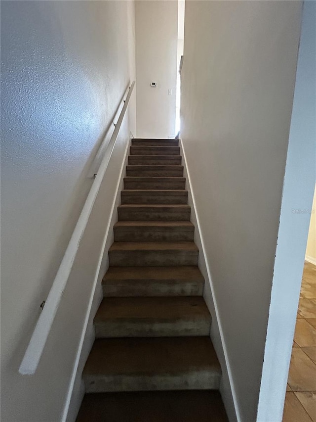 stairway with tile patterned flooring