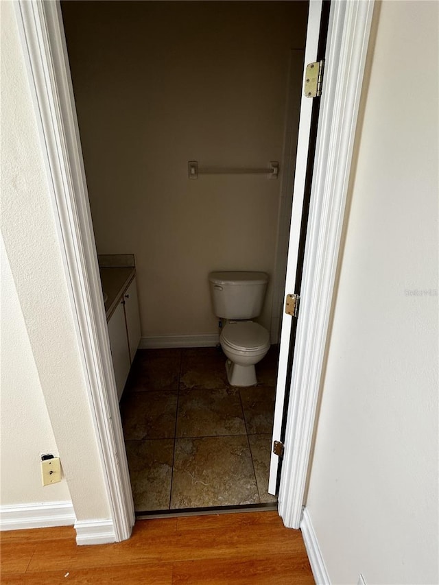 bathroom featuring hardwood / wood-style flooring, vanity, and toilet