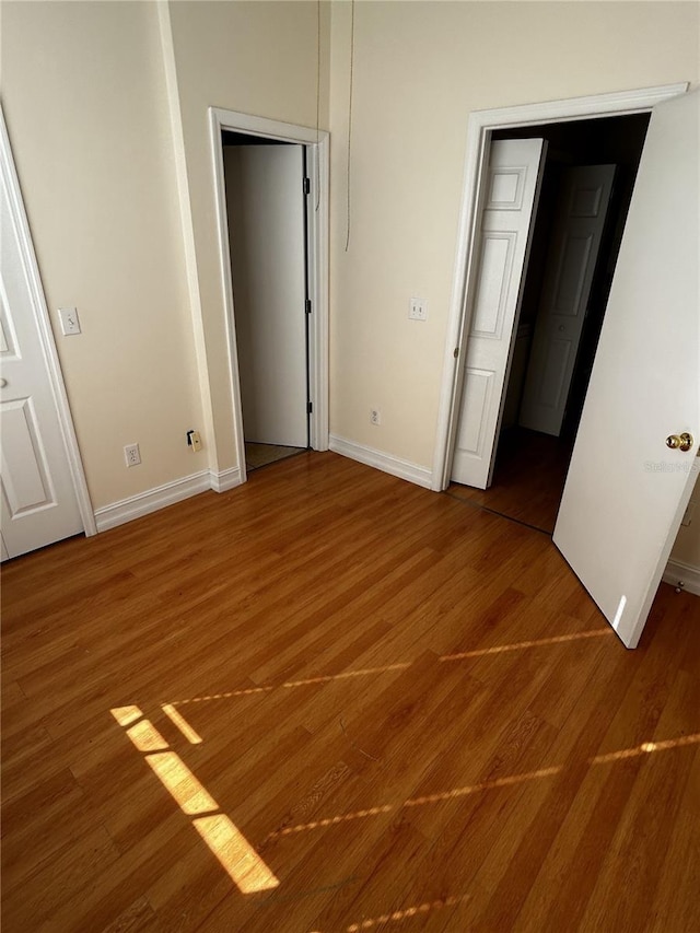 unfurnished bedroom with hardwood / wood-style flooring