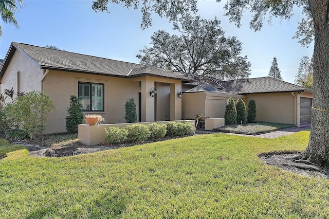 single story home featuring a front lawn and a garage