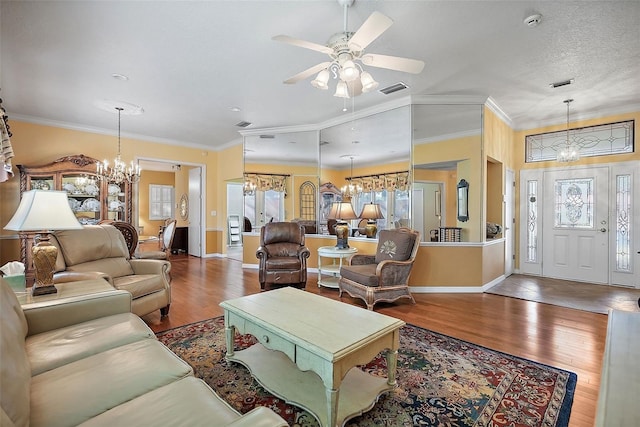 living room with crown molding, hardwood / wood-style floors, and ceiling fan with notable chandelier