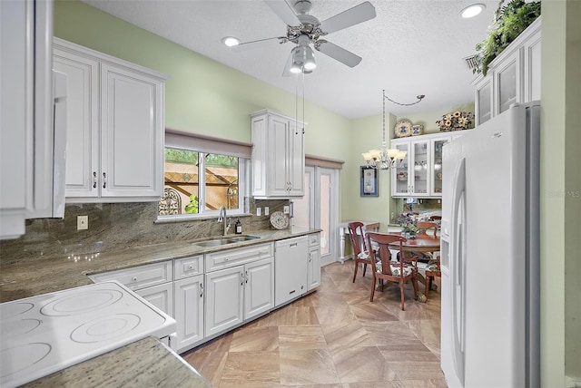 kitchen with white cabinetry, white appliances, and hanging light fixtures