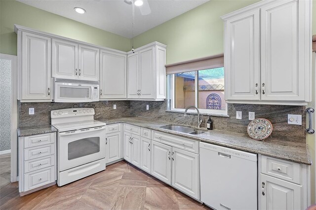 kitchen featuring white cabinetry, white appliances, and sink