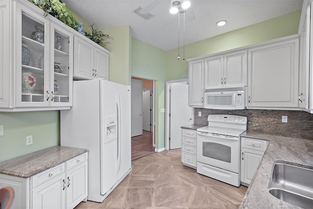 kitchen with backsplash, white cabinetry, sink, and white appliances