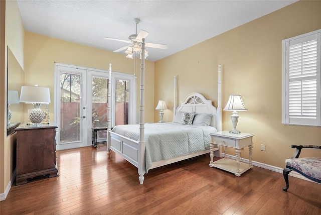 bedroom with french doors, dark hardwood / wood-style flooring, access to outside, and ceiling fan