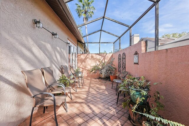 view of patio featuring a lanai