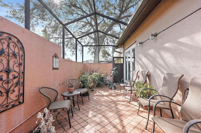 view of patio / terrace featuring glass enclosure