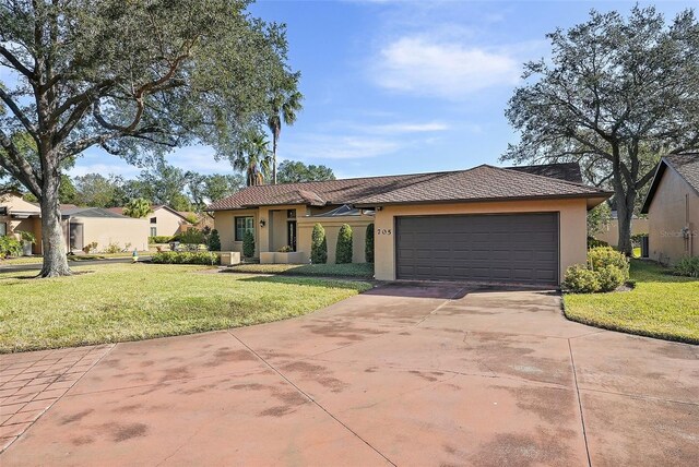 view of front of house with a garage and a front yard