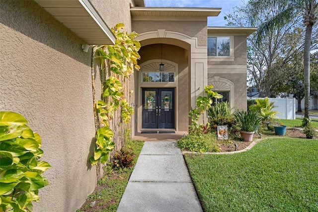 doorway to property with a lawn