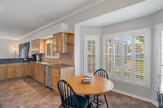 kitchen featuring dishwasher, sink, dark stone countertops, ornamental molding, and tasteful backsplash