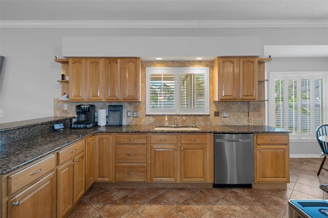 kitchen with dishwasher, crown molding, dark stone counters, and sink