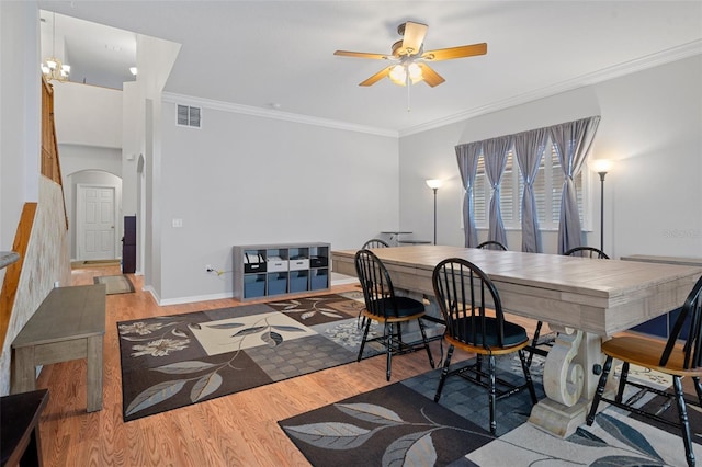 office area with crown molding, ceiling fan with notable chandelier, and hardwood / wood-style flooring