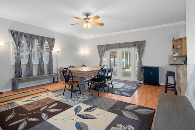 dining room with wood-type flooring, french doors, ceiling fan, and ornamental molding