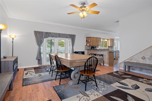 dining area featuring french doors, light hardwood / wood-style flooring, ceiling fan, and ornamental molding