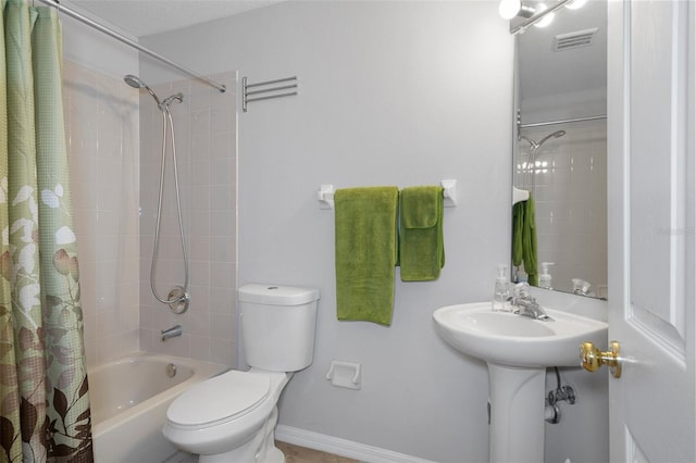 bathroom featuring toilet and shower / bath combo with shower curtain