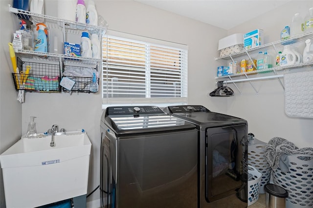 washroom with independent washer and dryer and sink