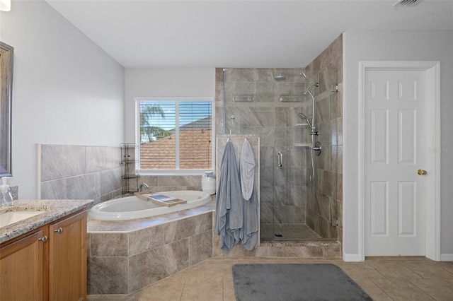 bathroom with plus walk in shower, vanity, and tile patterned floors