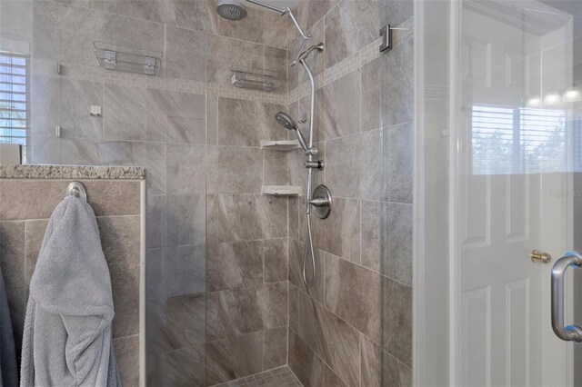 bathroom featuring a shower with door