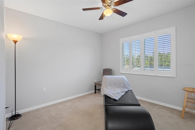 sitting room featuring ceiling fan and light carpet