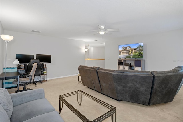 carpeted living room with ceiling fan