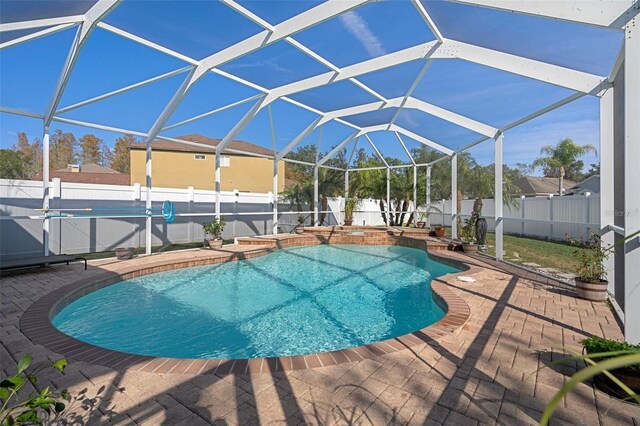 view of pool with a patio area and a lanai