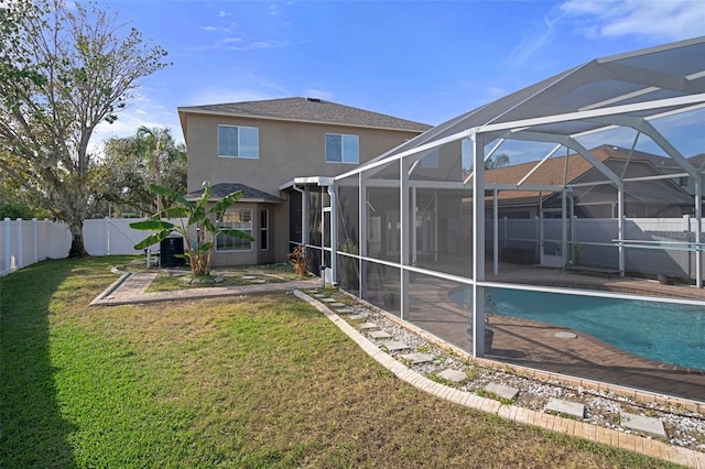 rear view of property with glass enclosure, a fenced in pool, and a yard