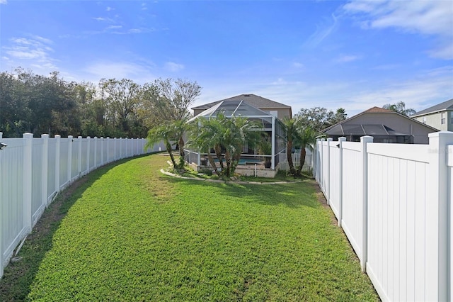 view of yard featuring a lanai and a swimming pool