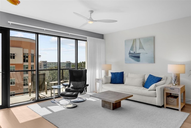 living room featuring hardwood / wood-style flooring and ceiling fan