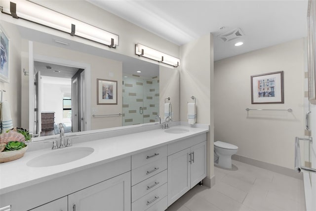 bathroom featuring tile patterned flooring, vanity, toilet, and an enclosed shower