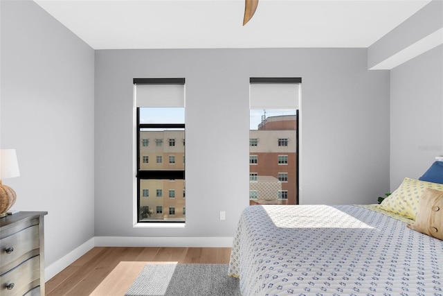 bedroom with ceiling fan and light wood-type flooring