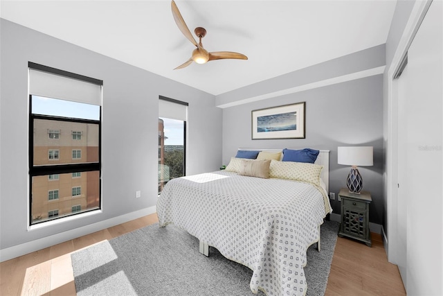 bedroom with light hardwood / wood-style floors and ceiling fan