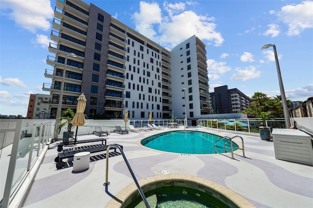 view of pool with a patio and a hot tub