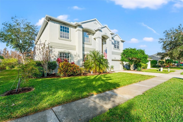 view of front of house with a garage and a front lawn