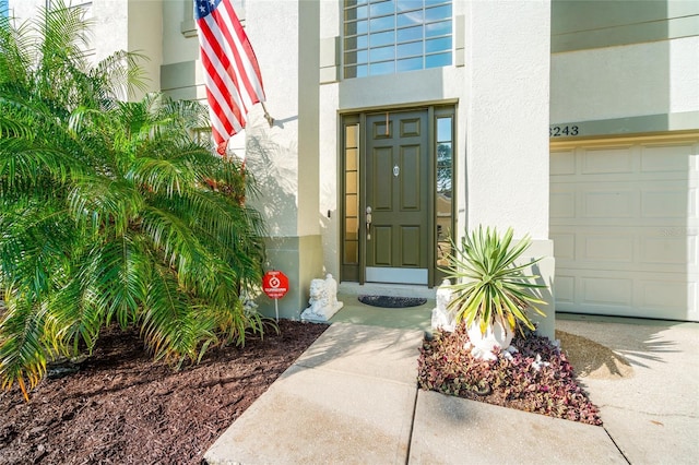 view of exterior entry featuring a garage