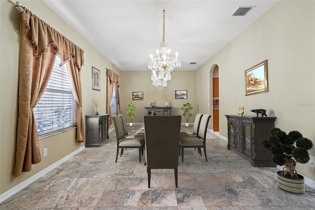 dining space with an inviting chandelier