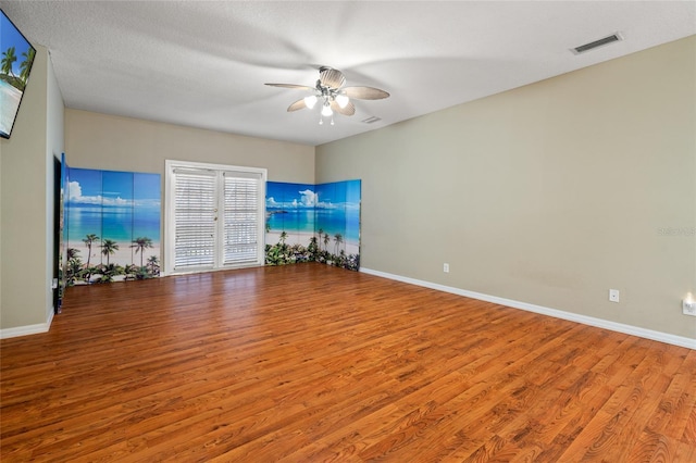 unfurnished living room with ceiling fan, light wood-type flooring, and a textured ceiling