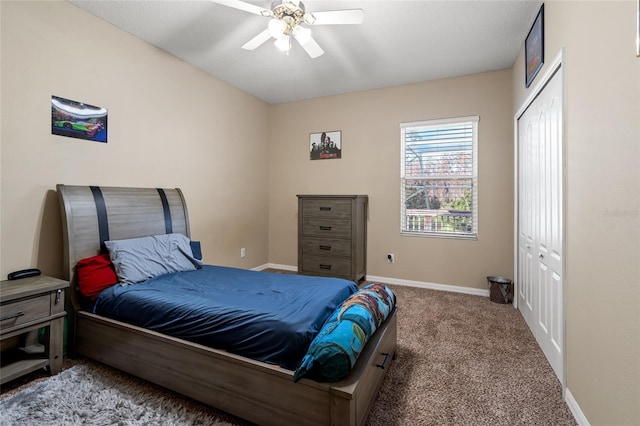 carpeted bedroom featuring ceiling fan and a closet