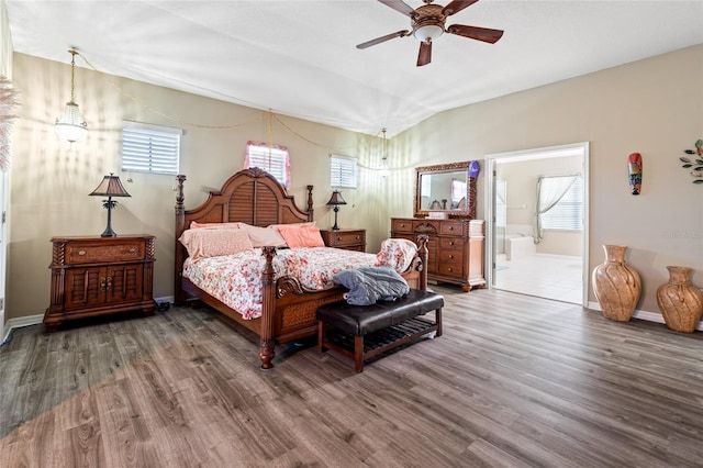 bedroom with multiple windows, wood-type flooring, ensuite bathroom, and ceiling fan