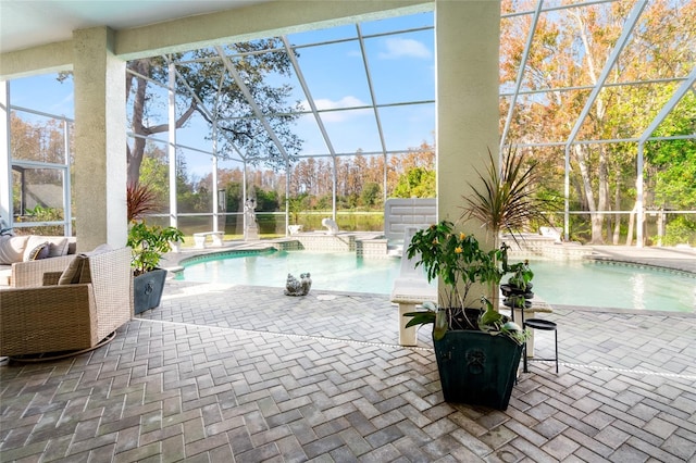 view of pool with pool water feature, a lanai, and a patio area