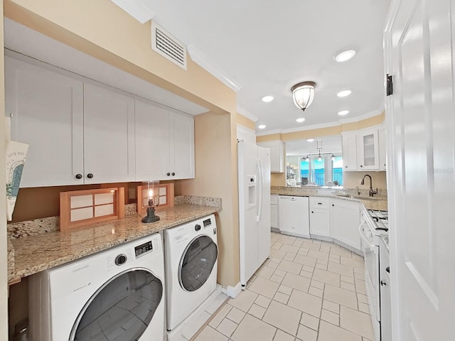 laundry area with separate washer and dryer, sink, light tile patterned floors, and ornamental molding