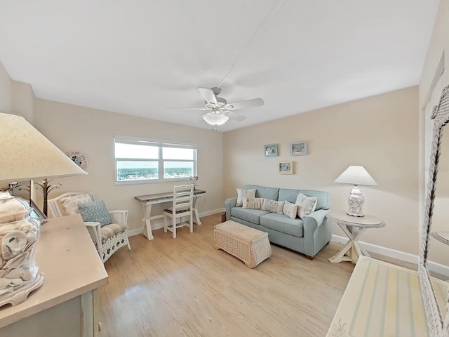 living room featuring light hardwood / wood-style flooring and ceiling fan