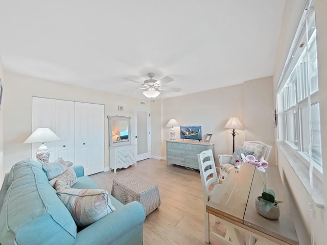 bedroom with ceiling fan, a closet, and light hardwood / wood-style flooring