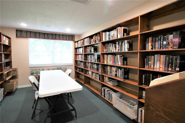 office area featuring a textured ceiling and dark carpet