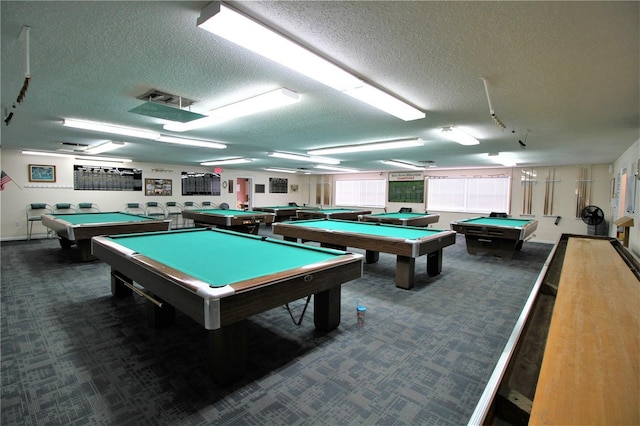 game room with dark colored carpet, a textured ceiling, and billiards