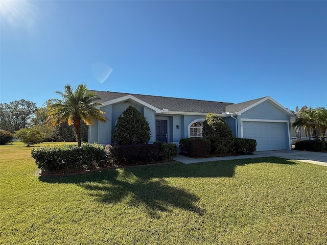 ranch-style house featuring a front yard and a garage