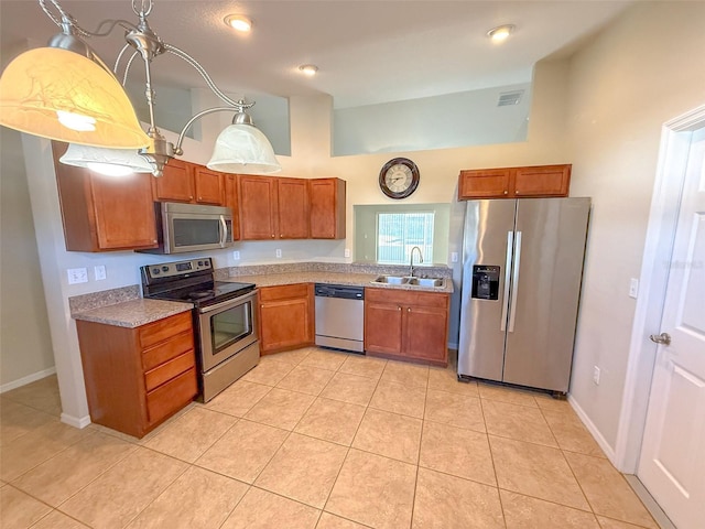 kitchen featuring sink, light tile patterned floors, and stainless steel appliances