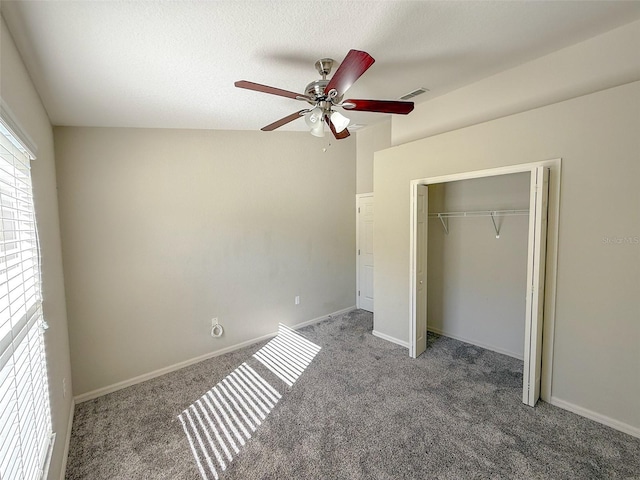 unfurnished bedroom featuring carpet, ceiling fan, a textured ceiling, and a closet