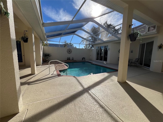 view of swimming pool with a lanai and a patio