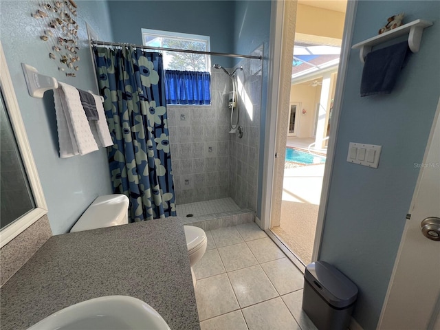 bathroom featuring toilet, sink, tile patterned flooring, and a shower with shower curtain