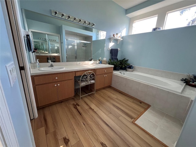 bathroom with vanity, hardwood / wood-style flooring, and independent shower and bath